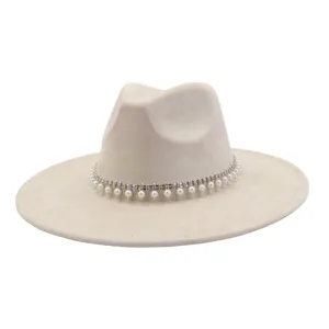 Close-up detail of beige suede jazz hat featuring rhinestone pearl tassel band decoration.