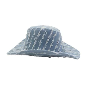 Close-up detail of the blue denim frayed sun hat, showing unique distressed fringe texture.