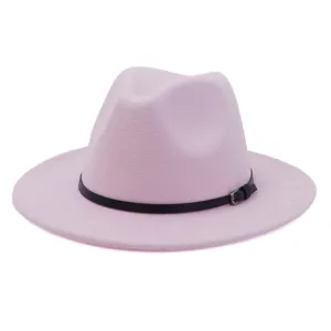 Close-up detail view of pink felt fedora hat highlighting soft woolen texture and belt.