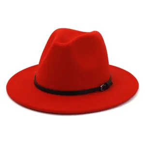 Close-up detail of the elegant red fedora hat with a sleek black leather belt and metal buckle.