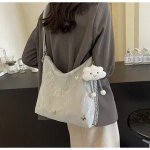 Stylish casual shoulder bag detailed with metallic butterflies and cute cloud pendant.