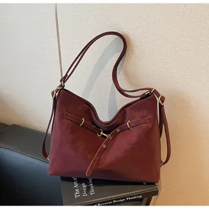 Wine red vintage shoulder bag detail view, multi-use casual tote design with metallic hardware.