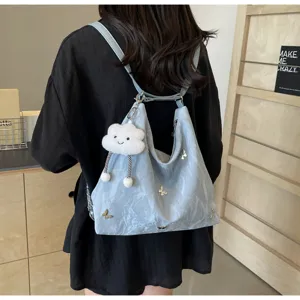 Light blue multi-functional tote bag with cute butterfly charms and plush cloud pendant.
