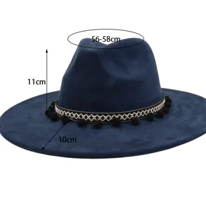 Detailed view of dark blue suede jazz hat, wide brim design with woven band and pom poms.