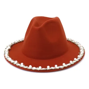 Close-up of elegant wool fedora hat featuring a stunning pearl and rhinestone brim trim.