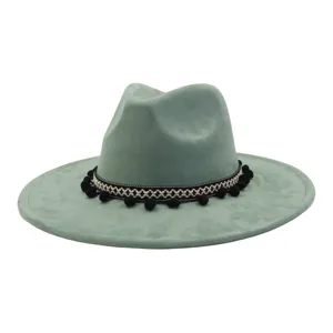Green faux suede fedora hat with bohemian woven band and pom poms for men and women detail view