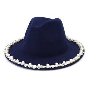 Detailed view of a navy blue felt fedora hat decorated with chic pearl beaded brim.