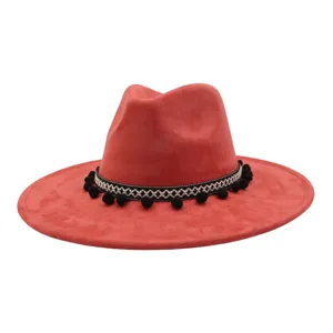 Detail view of the red suede jazz hat, featuring woven black and white band and cute black pom poms.