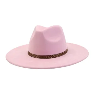 Pink suede fedora hat detail view, wide brim design with brown geometric woven decorative band.