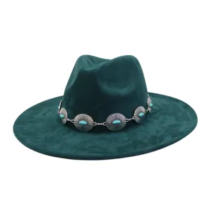 Green suede fedora hat detailed with turquoise metal band, close-up view of bohemian style.