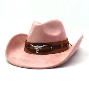 Pink suede western cowboy hat detail showing brown leather band and metal bull skull decor.