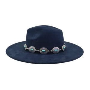 Close-up detail of the vintage ethnic turquoise stone metal decorative band on suede fedora hat.