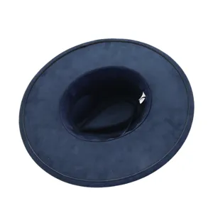 Close-up detail of the navy blue wide brim suede fedora hat showing soft texture and brim.