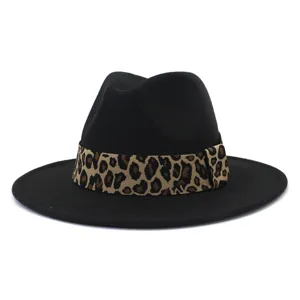 Black fedora hat detail showing leopard print band and wide wool brim closeup.