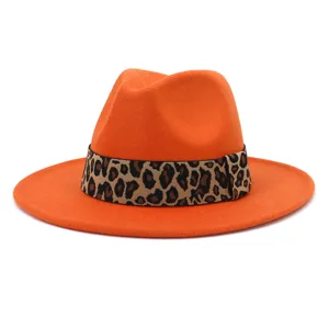 Close-up of orange wool fedora hat with trendy leopard print band and wide brim design.