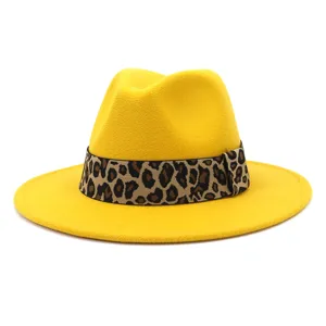 Detailed view of the yellow fedora hat showing its exquisite leopard print ribbon and texture.