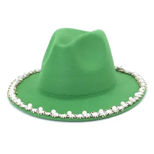Close-up detail of the green wool fedora hat featuring elegant pearl and rhinestone brim trim.