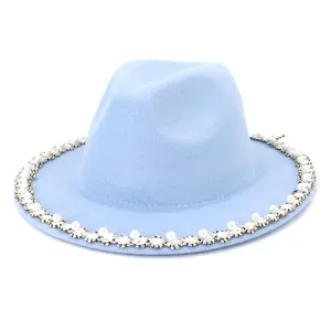 Close-up detail of light blue wool fedora hat featuring elegant pearl and rhinestone brim trim.