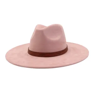 Close-up detail of the pink suede fedora hat featuring a brown patterned leather band.