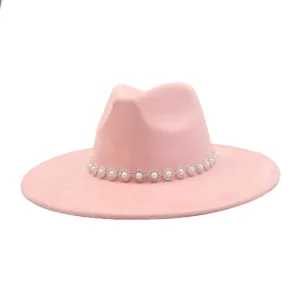 Pink faux suede fedora hat detail featuring sparkling pearl and rhinestone flower band design.