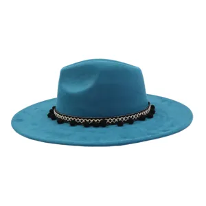 Turquoise wide brim suede fedora hat with ethnic pom pom band, stylish detail view.
