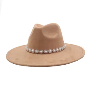 Close-up detail of stylish camel suede fedora hat featuring a elegant pearl crystal flower chain band.