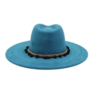 Turquoise soft suede fedora hat featuring black white woven band and pom poms detail.