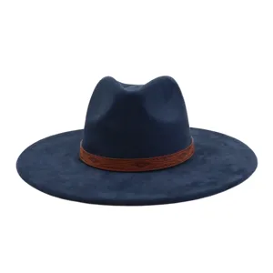 Close-up detail of a navy blue suede fedora hat featuring a brown embossed tribal leather band.