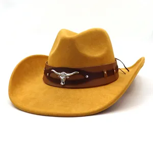 Classic suede western cowboy hat with leather band and metal bull skull decor, detail view.