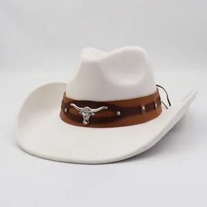 Close-up detail of white suede cowboy hat, featuring brown leather band and silver bull accent.