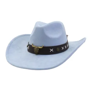 Close-up detail of light blue suede cowboy hat, vintage bull skull buckle and brown band.