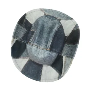 Close-up detail of the vintage patchwork denim cowboy hat with wide brim, stylish western design.