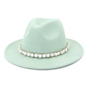 Light green wool fedora hat detail featuring elegant pearl and metallic woven trim decoration.