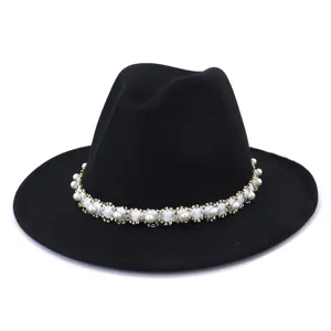 Close-up detail of elegant black wool fedora hat featuring exquisite pearl and beaded trim band.
