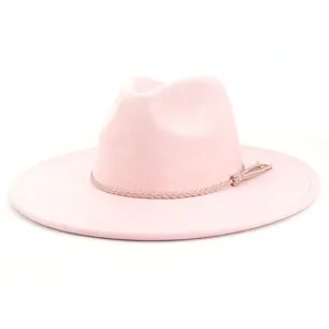 Close-up detail of the pink suede fedora hat showcasing the delicate braided band and tassel.