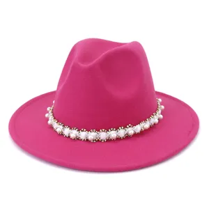 Pink felt fedora hat detail featuring an elegant white pearl and beaded trim band design.