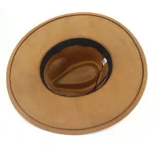 Detailed interior view of a brown suede fedora hat, showing inner band and care label.