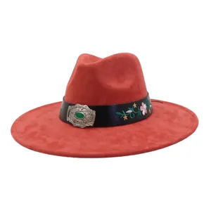 Close-up detail of red suede fedora hat with black belt, floral embroidery and silver buckle.