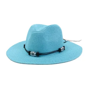 Blue straw sun hat detail with black cord and floral beads, casual summer beach wear accessory.