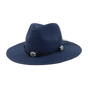 Navy blue straw sun hat with black band and white floral beads detail for outdoor beach wear.
