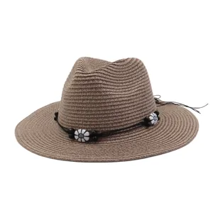 Straw hat detail showcasing woven texture, black decorative cord, and stylish flower beads.