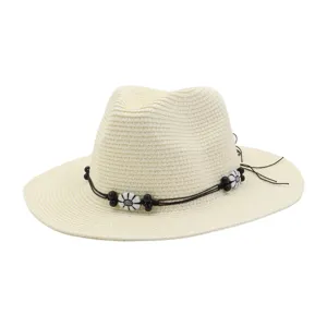 Detailed view of the summer straw sun hat featuring a charming black cord band with cute flower beads.