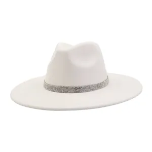 Close-up detail of white suede fedora hat with sparkling rhinestone band, elegant brim view.