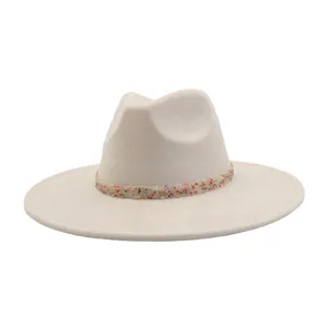 Beige wide-brim fedora hat detail showing colorful beaded band texture and soft suede fabric.