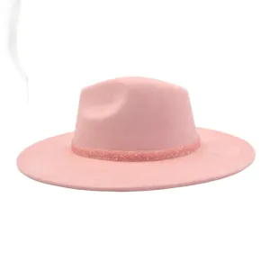 Detailed close-up of the pink suede fedora hat showcasing its sparkly decorative band.