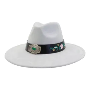 Close-up of a light grey jazz hat featuring a black leather band, silver buckle, and floral embroidery.