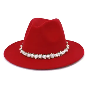 Detailed view of the red wool fedora hat featuring elegant pearl and bead trim band.