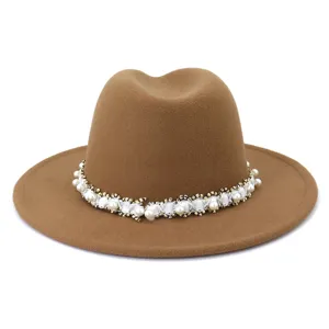 Detail shot of brown wool fedora hat with elegant pearl beaded decorative band for women.