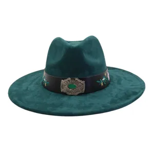 Close-up of dark green suede fedora hat detail, featuring black embroidered leather band, silver buckle.