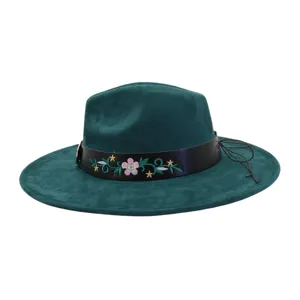 Dark green suede jazz hat with embroidered floral leather band, stylish flat brim fedora.
